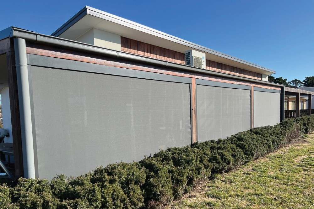 Zip-track awnings installed by Designing Windows, providing shade for properties in North Canberra and Sutton